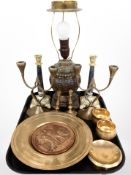 A group of brass wares, two pairs of ornate candlesticks, embossed plaque,