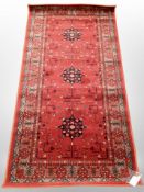 A machine made rug of Afghan design,