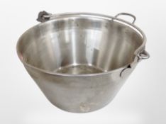 A stainless steel swing handled jam pan