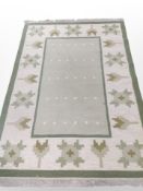 A kilim carpet on green ground,