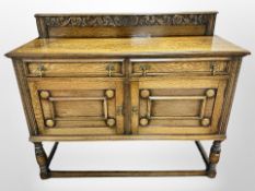 An Edwardian carved oak sideboard,
