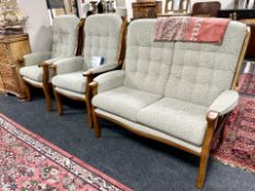 A contemporary stained beech framed three piece lounge or conservatory suite,