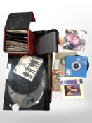 A box containing Sony turntable, vinyl 45 singles and a Bose SoundDock series II music system.