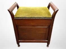 An Edwardian mahogany storage piano stool,