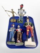 A brass figure of a man holding a lance,