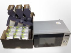A commercial microwave and a box containing Good Home kitchen canister sets and Diall timer plugs