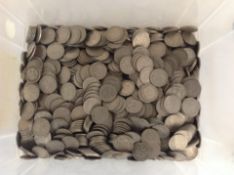 A plastic tub containing a very large quantity of six pences.