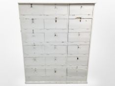 A Victorian painted pine bank of eighteen pigeon hole shelves,