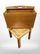 A 1970's teak magazine rack with swing handle,