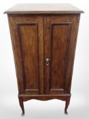 An Edwardian music cabinet containing a quantity of pianola rolls 52 cm wide x 44 cm deep x 107 cm