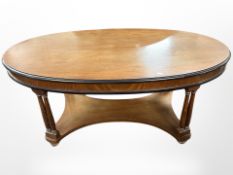 A reproduction mahogany oval coffee table,