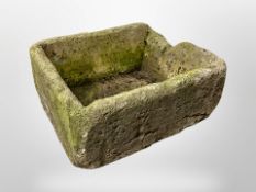 A weathered concrete garden planter,