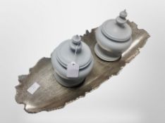 A contemporary aluminium center dish, width 56cm, pair of resin lidded urns.