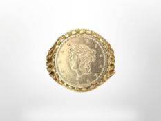 A 9ct gold ring inset with an American 1853 gold tallar coin, size L.