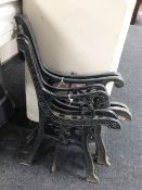 Two pairs of cast iron bench ends