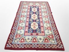 A 1970's woolen rug of Eastern design,