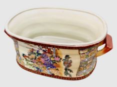 A Japanese export earthenware twin-handled foot bath, width 49cm.
