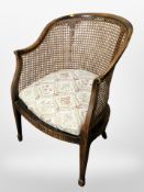 A beech bergere open armchair,