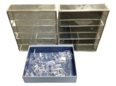 Two glazed metal-framed display cabinets, width 30cm, and a quantity of plastic stands.