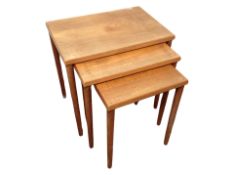 A teak nest of three tables,