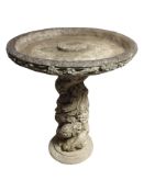 A concrete pedestal bird bath,