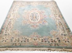 A Chinese carpet on pale turquoise ground,