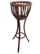 An Edwardian bentwood jardiniere stand,