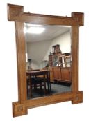 A carved oak bevelled overmantel mirror, 90cm x 70cm.