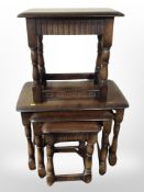 A reproduction oak nest of tables and a further stool