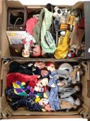 A wooden puppet theatre frame and two boxes containing assorted homemade puppets and related items.