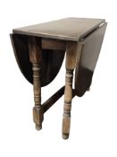 An Ercol oak drop leaf dining table and a set of four chairs