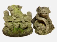 Two concrete garden pig figures,