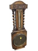 A carved oak barometer,