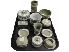 Twelve pieces of Wedgwood green Jasperware including trinket boxes, urns, vases, etc.
