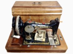 A Frister & Rossmann hand sewing machine in walnut case