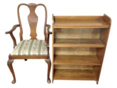 A walnut open armchair on cabriole legs together with a sliding glass door bookcase