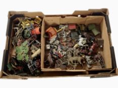 A box of vintage painted diecast metal farm animals and structures, etc.