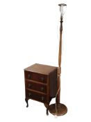 A mahogany three drawer low chest and a standard lamp