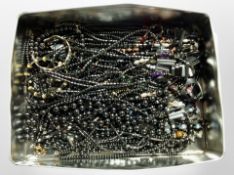 A tin containing hematite jewellery.