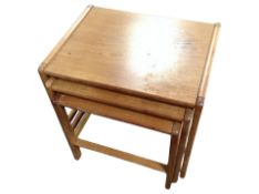 A teak nest of three tables,
