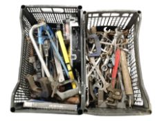 Two crates containing assorted hand tools, vices, etc.