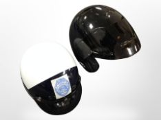 A motorbike helmet marked 'Hawaii County Police', together with a Nolan motorcycle helmet type A.