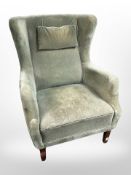 An early 20th century wingback armchair