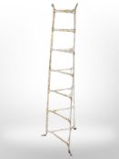 A painted wrought metal plant trellis,