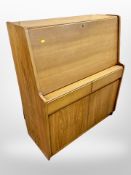 A 20th century teak fall fronted bureau,