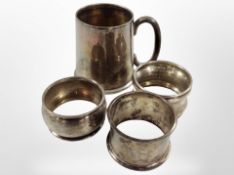 A silver Christening mug and three napkin rings. CONDITION REPORT: 106g gross.