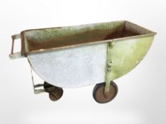 A galvanised metal wheel barrow,