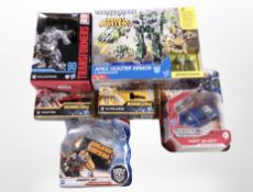 A group of Hasbro and Tomy Transformers action figures.