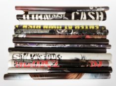 A group of rolled posters including music, Star Wars, video games, etc.