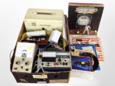 A box containing wattmeter, voltmeter, other components, small quantity of records.
